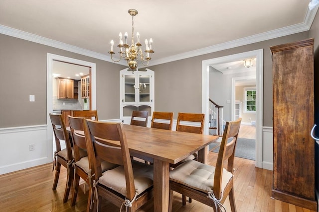 103 Randlett Park, Newton, MA 02465 - dining area with a chandelier, light wood-style flooring, and ornamental molding