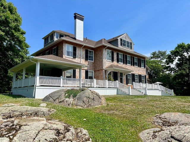 rear view of property with a yard