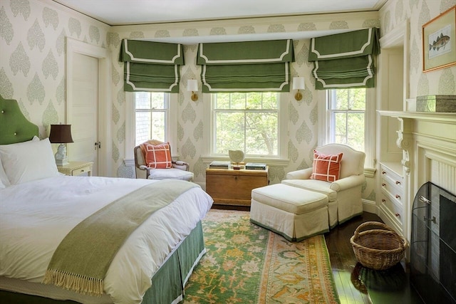 bedroom featuring crown molding, multiple windows, and hardwood / wood-style floors