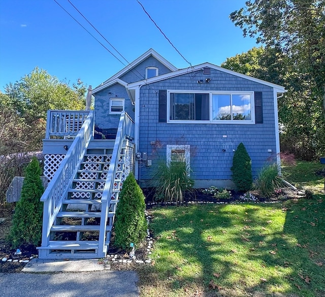 view of front of home with a front yard and a deck