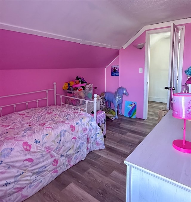 bedroom with lofted ceiling and wood-type flooring