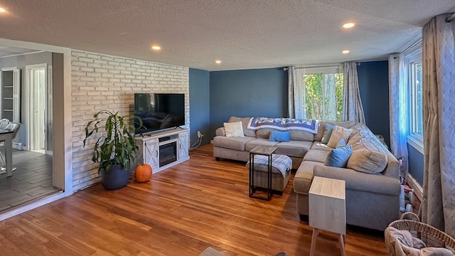 living room featuring hardwood / wood-style floors and a textured ceiling