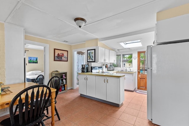 64 Bayside Dr, Falmouth, MA 02540 - kitchen with freestanding refrigerator, white cabinets, light countertops, light tile patterned floors, and electric range oven