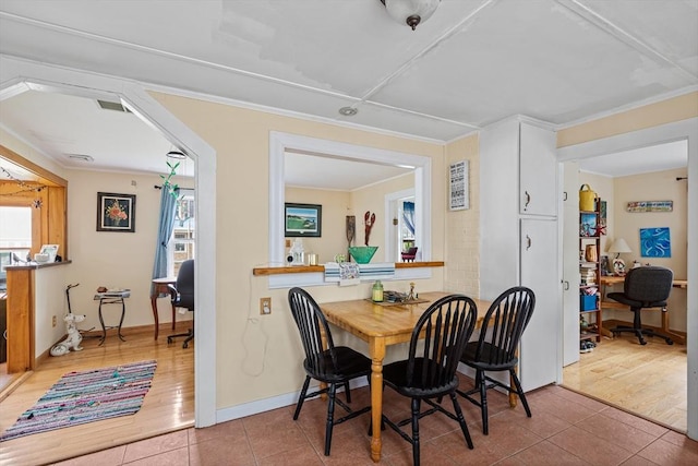 64 Bayside Dr, Falmouth, MA 02540 - tiled dining area featuring a desk, ornamental molding, and baseboards