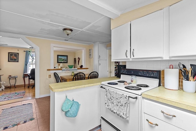 64 Bayside Dr, Falmouth, MA 02540 - kitchen with electric range, decorative backsplash, tile patterned flooring, and light countertops
