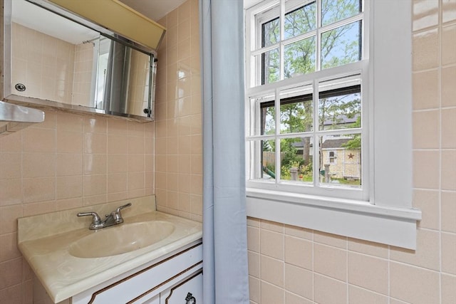 64 Bayside Dr, Falmouth, MA 02540 - bathroom featuring healthy amount of natural light, tile walls, and vanity
