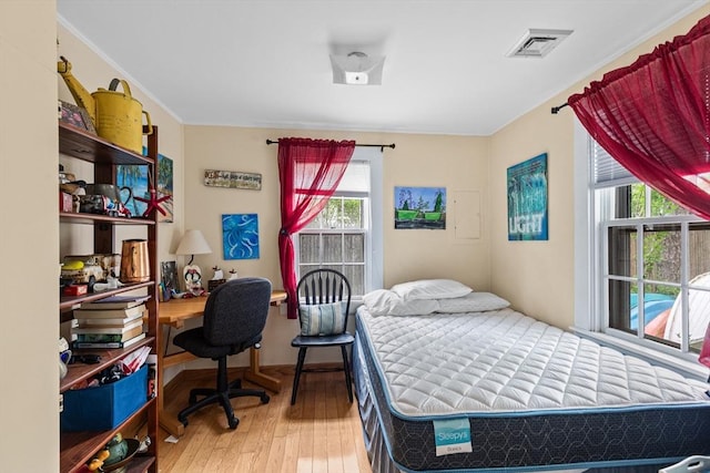 64 Bayside Dr, Falmouth, MA 02540 - bedroom with wood-type flooring, crown molding, and a desk