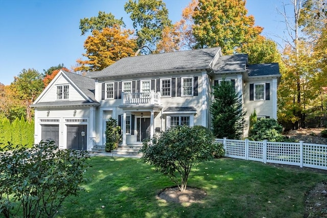 colonial house with a garage and a front lawn