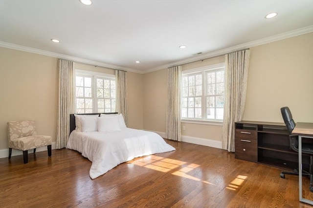 bedroom featuring crown molding, wood-type flooring, and multiple windows