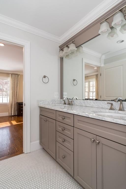 bathroom with ornamental molding and vanity