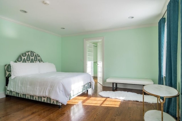 bedroom featuring hardwood / wood-style flooring and crown molding