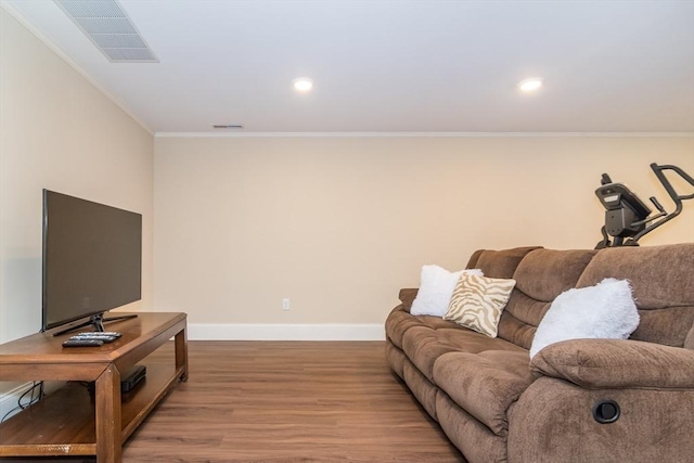 living room featuring ornamental molding and light wood-type flooring