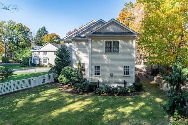 rear view of house featuring a yard