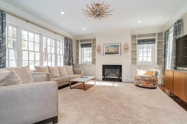 living room featuring crown molding, plenty of natural light, and built in features