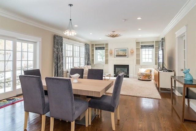 dining space with ornamental molding, plenty of natural light, and dark hardwood / wood-style flooring