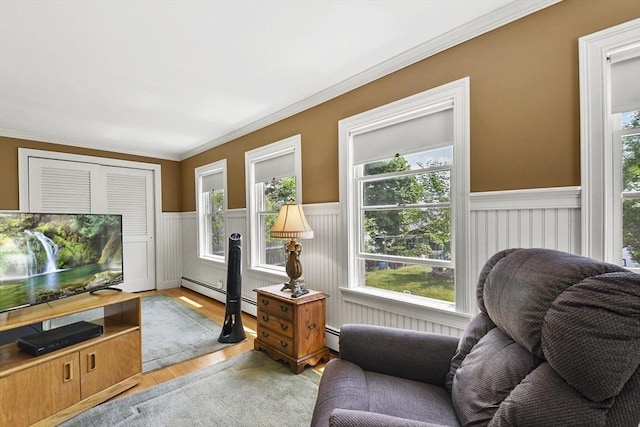 9 Aspinwall Ave, Weymouth, MA 02191 - sitting room featuring wainscoting, crown molding, light wood-style floors, and baseboard heating