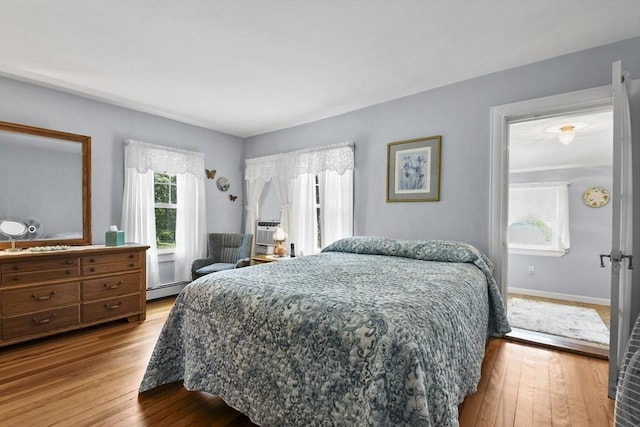 9 Aspinwall Ave, Weymouth, MA 02191 - bedroom featuring wood-type flooring, a baseboard heating unit, and baseboards