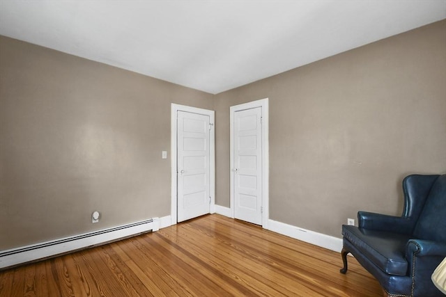 9 Aspinwall Ave, Weymouth, MA 02191 - sitting room featuring a baseboard radiator, baseboards, and wood finished floors