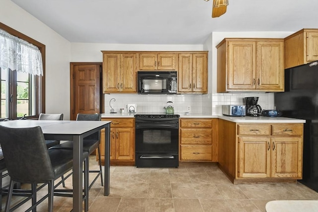 9 Aspinwall Ave, Weymouth, MA 02191 - kitchen with black appliances, backsplash, light countertops, and brown cabinetry