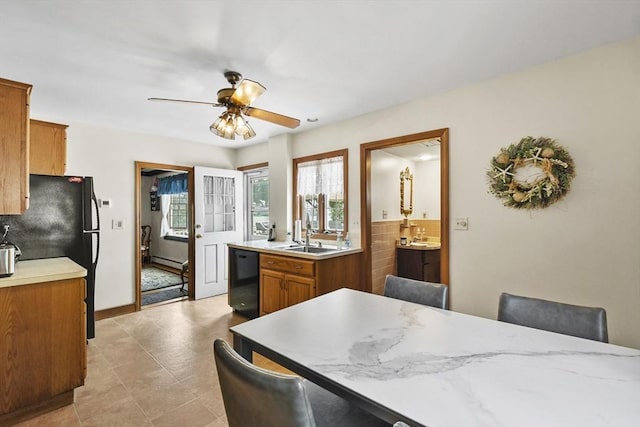 9 Aspinwall Ave, Weymouth, MA 02191 - kitchen featuring black appliances, brown cabinets, light countertops, ceiling fan, and backsplash
