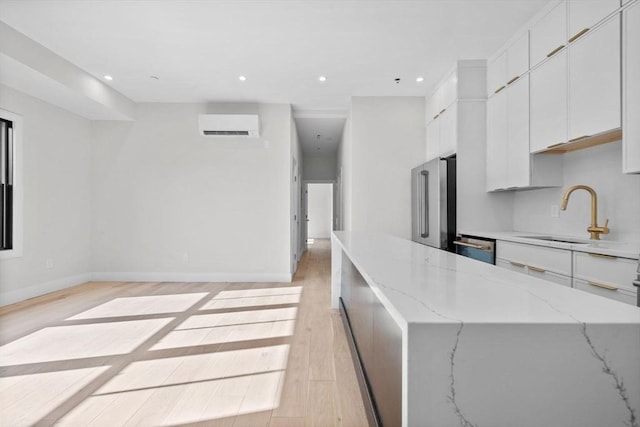 1 Marion St Unit 2, Cambridge, MA 02141 - kitchen featuring a sink, appliances with stainless steel finishes, light wood-style flooring, white cabinets, and recessed lighting