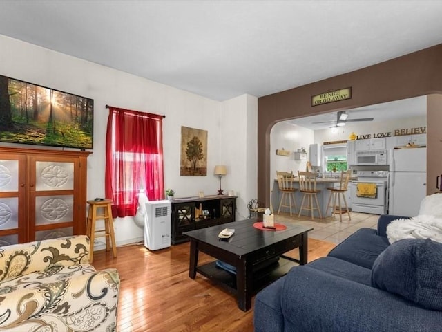 135 Border St Unit 135, Northbridge, MA 01588 - living area with a ceiling fan, arched walkways, and light wood-style floors