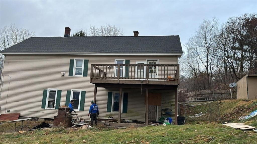 54 Marietta St, North Adams, MA 01247 - back of house featuring a wooden deck, a chimney, and a lawn