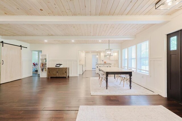 39 Chestnut St, Hopkinton, MA 01748 - entryway with a barn door, dark wood-type flooring, a decorative wall, a wainscoted wall, and wooden ceiling with exposed beams