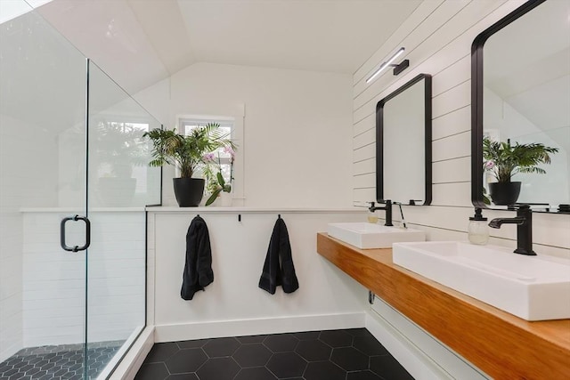 39 Chestnut St, Hopkinton, MA 01748 - full bathroom with tile patterned flooring, vaulted ceiling, a shower stall, double vanity, and baseboards
