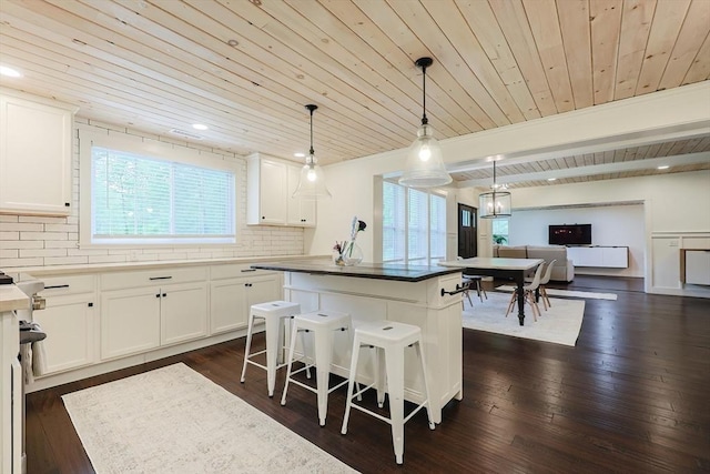 39 Chestnut St, Hopkinton, MA 01748 - kitchen featuring wooden ceiling, plenty of natural light, decorative backsplash, a center island, and white cabinets