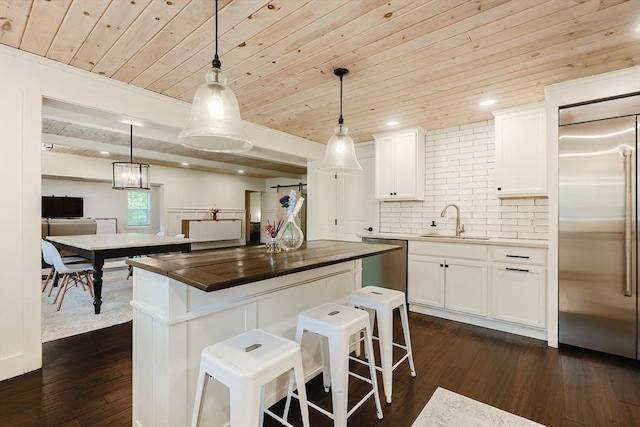39 Chestnut St, Hopkinton, MA 01748 - kitchen with appliances with stainless steel finishes, a sink, wooden ceiling, dark wood-style flooring, and white cabinets