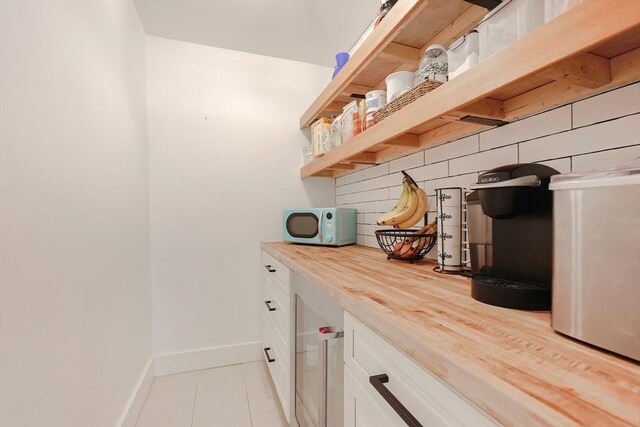 39 Chestnut St, Hopkinton, MA 01748 - bar area featuring baseboards and light tile patterned flooring