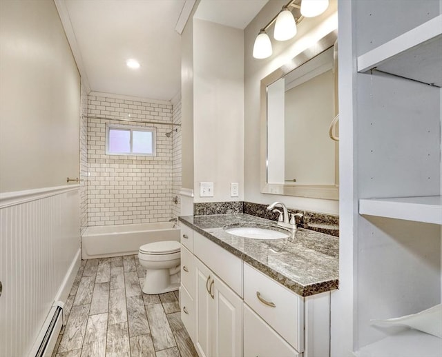 full bathroom featuring a baseboard radiator, vanity, toilet, and tiled shower / bath