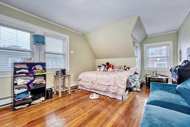 bedroom featuring hardwood / wood-style flooring, lofted ceiling, and multiple windows