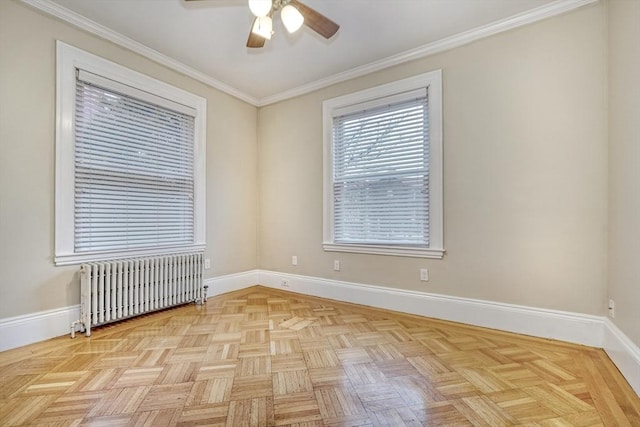 spare room featuring ceiling fan, radiator heating unit, ornamental molding, and light parquet floors