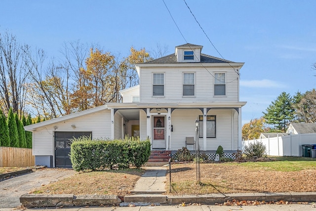 view of front facade with a garage and a porch