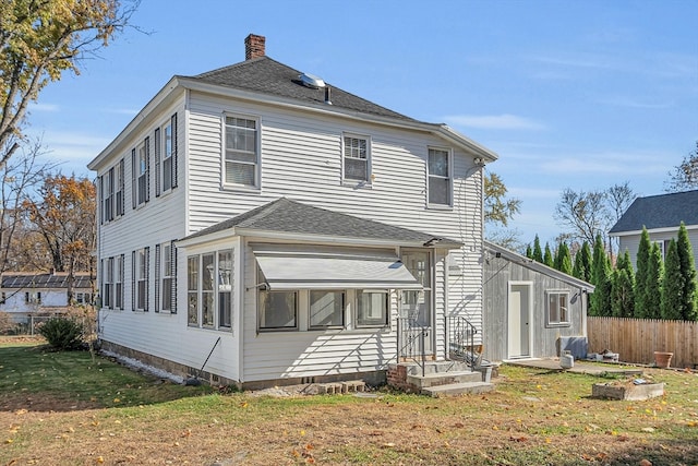 rear view of house with a lawn