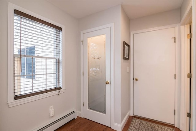 doorway featuring a baseboard heating unit and dark wood-type flooring