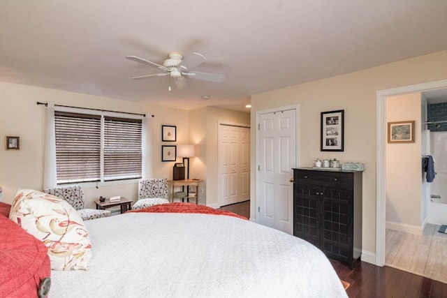 bedroom with dark hardwood / wood-style flooring and ceiling fan