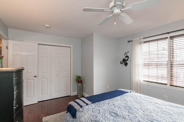 bedroom with dark wood-type flooring, ceiling fan, and a closet