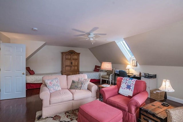 interior space featuring dark hardwood / wood-style flooring, vaulted ceiling with skylight, and ceiling fan