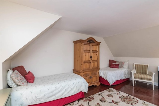 bedroom with dark hardwood / wood-style flooring and vaulted ceiling