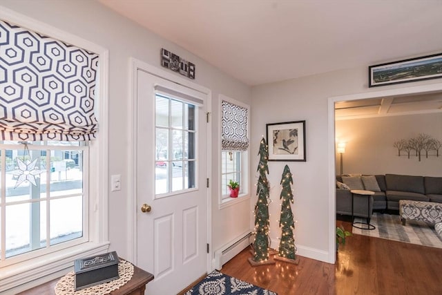 entryway with a baseboard heating unit, dark wood-type flooring, and plenty of natural light