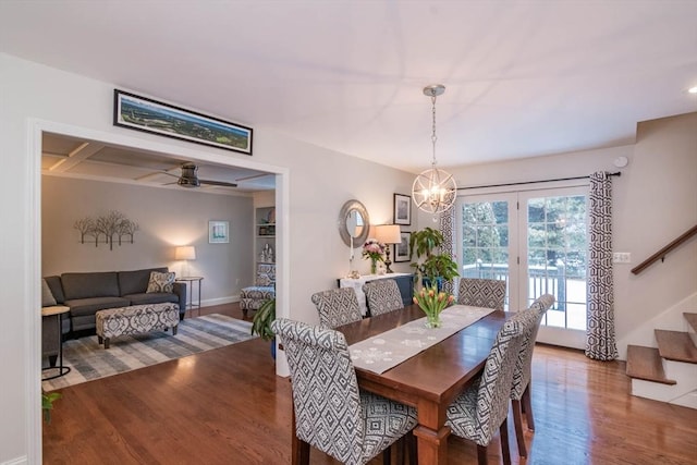 dining space featuring hardwood / wood-style floors and ceiling fan with notable chandelier