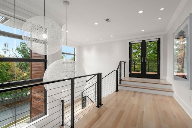 hallway featuring crown molding, recessed lighting, visible vents, wood finished floors, and a chandelier