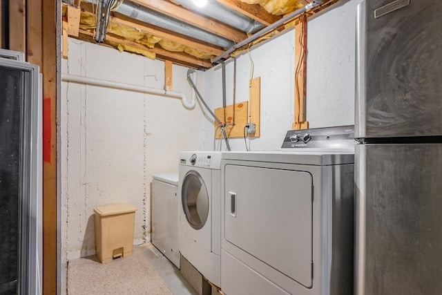 laundry area featuring washer and clothes dryer and laundry area