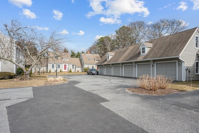 view of road with community garages and a residential view