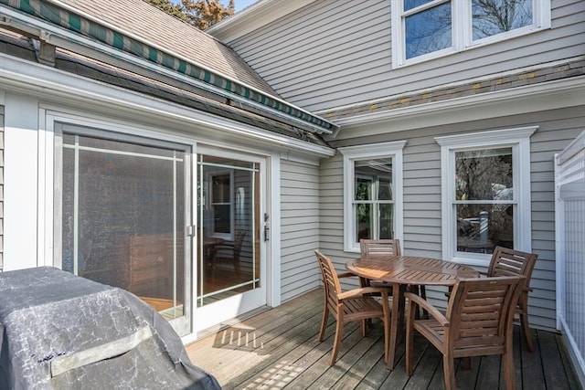 wooden deck featuring outdoor dining area