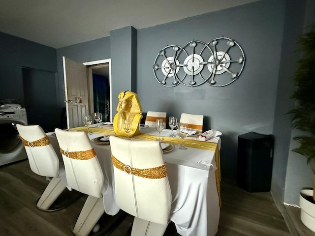 dining area with washer / dryer and wood finished floors