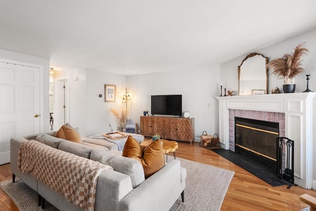 128 Parker St Unit 4C, Acton, MA 01720 - living area featuring a fireplace and light wood-style floors